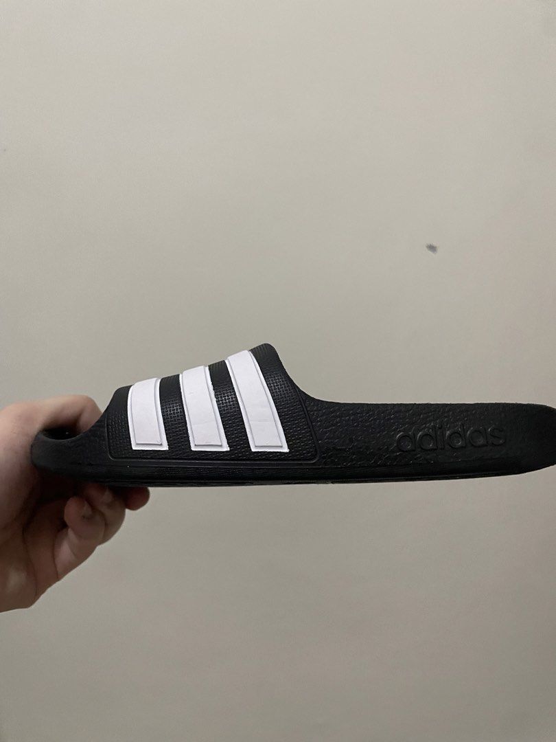 Adidas Adilette Shower Slides Black White (Category: Babies & Kids Fashion) located in Manila. Submitted by beatan13 (Listing ID 1443124331, Image 3). Description: - Classic Adidas slides - Color: Black with white stripes - Comfortable for everyday wear or after sports - Easy slip-on and off design - Ideal for pool or lounging - A casual wardrobe essential.