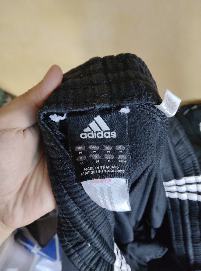 Adidas Black Track Pants with White Stripes (Category: Joggers) located in Manila. Submitted by kid.indigo (Listing ID 1443029080, Image 2). Description: - Classic black Adidas track pants - Iconic white three stripes down the sides - Comfortable elastic waistband - Ideal for sports or casual wear - Pair with sneakers for a complete sporty look.