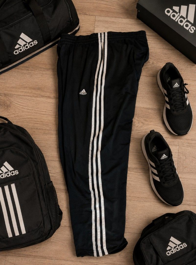 Adidas Black Track Pants with White Stripes (Category: Joggers) located in Manila. Submitted by kid.indigo (Listing ID 1443029080, Image 1). Description: - Classic black Adidas track pants - Iconic white three stripes down the sides - Comfortable elastic waistband - Ideal for sports or casual wear - Pair with sneakers for a complete sporty look.