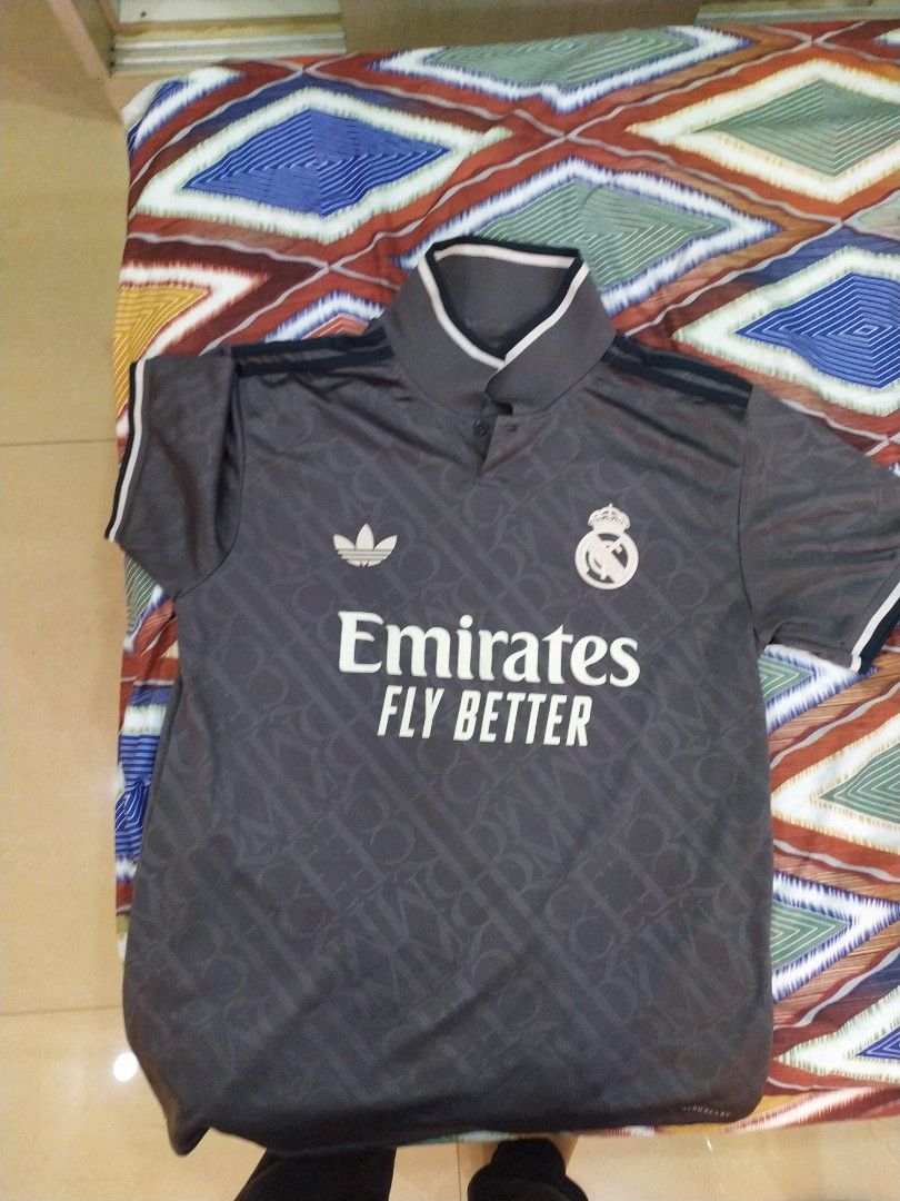 Adidas Real Madrid 2022/23 Away Jersey XL (Category: Activewear) located in Singapore. Submitted by special_sarees4 (Listing ID 1443029536, Image 2). Description: - Grey Adidas Real Madrid away jersey - Emirates Fly Better sponsor - Size: XL - Fit: Slim fit - Features: Adidas logo and Real Madrid crest - Design: Subtle all-over pattern - Ideal for: Real Madrid fans.