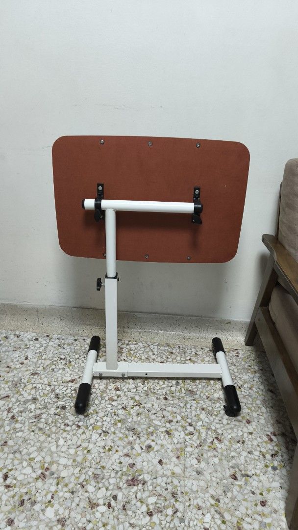 Adjustable Height Table (Category: Tables & Sets) located in Singapore. Submitted by echenen (Listing ID 1443060325, Image 3). Description: - Side table for laptop, reading, etc - Adjustable height - Adjustable angle - Wood-grain finish top - White metal base with black feet - Ideal for couch or bed use - Compact and easy to move/store - Selling cheap because of the two small cracks on the surface. (see pics).