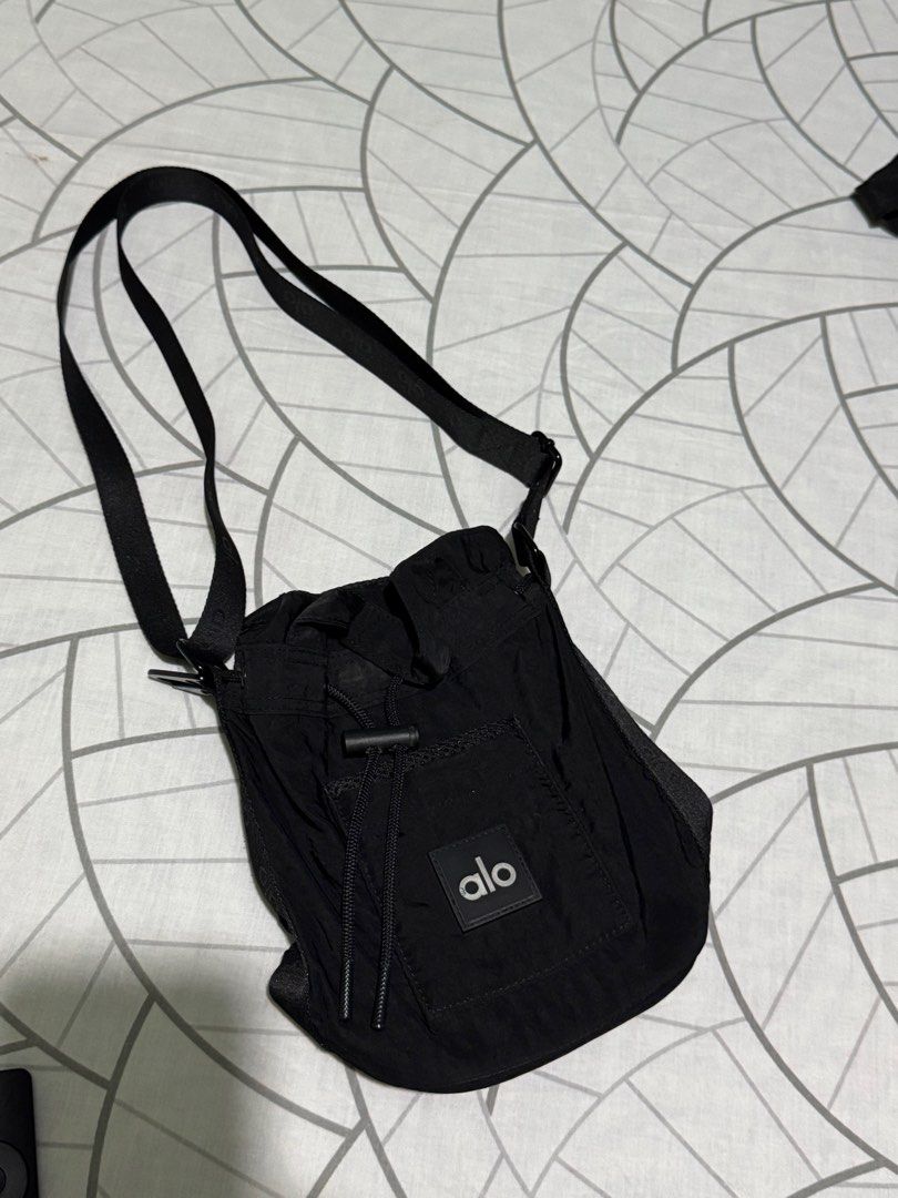 Alo Yoga Black Drawstring Bucket Bag One Size (Category: Cross-body Bags) located in Bulacan. Submitted by elihoh (Listing ID 1443046733, Image 1). Description: - Brand new Alo Yoga bucket bag - Color: Black - Closure: Drawstring - Strap: Adjustable - Features: Front pocket with Alo logo - Condition: Original tags attached - Ideal for: Everyday use, gym sessions.