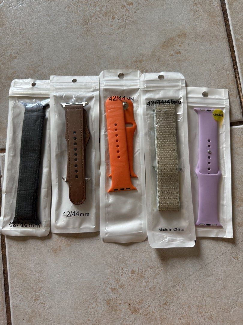 Apple Watch Bands 42/44/45mm - Multiple Colors (Category: Wearables & Smart Watches) located in Manila. Submitted by its.mickey (Listing ID 1443093806, Image 1). Description: - Bundle of 5 Apple Watch Bands - Compatible Sizes: 42mm, 44mm - Colors Included: Dark Grey, Brown, Orange, Beige, Purple - Material Mix: Fabric, Leather, Silicone - Easily switch up your Apple Watch style!.