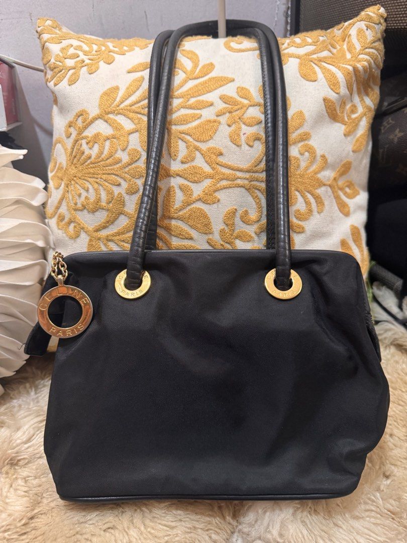 Authentic Celine Paris Black Nylon Tote Bag (Category: Luxury Bags & Wallets) located in San Pablo. Submitted by docannie3869170 (Listing ID 1443125193, Image 1). Description: - Celine Paris black nylon tote bag - Gold tone hardware - Circular logo charm - Made in Italy - Zipper closure - Classic piece for everyday use.