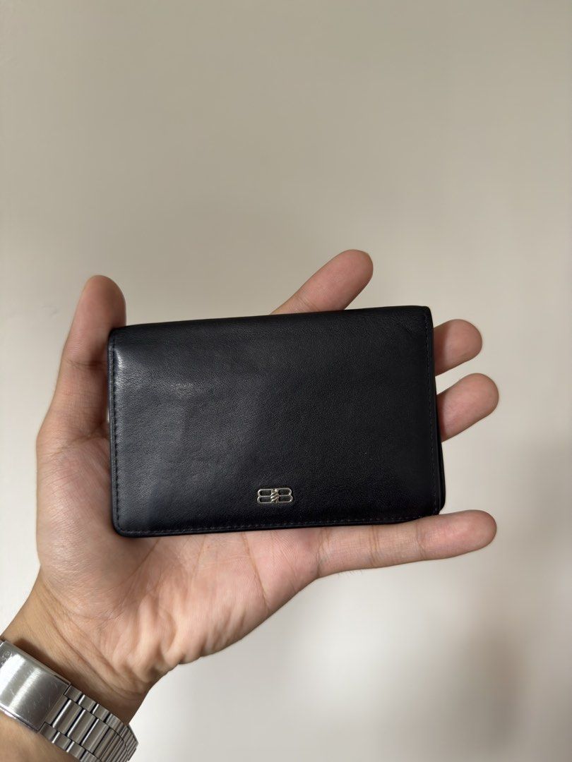 Balenciaga Black Leather Card Holder (Category: Luxury Bags & Wallets) located in Manila. Submitted by yourboy.ad (Listing ID 1442973779, Image 1). Description: - Authentic Balenciaga card holder - Color: Black leather - Embossed Balenciaga logo inside - Multiple card slots for organization - Slim and pocket-friendly design - Minimalist and stylish.