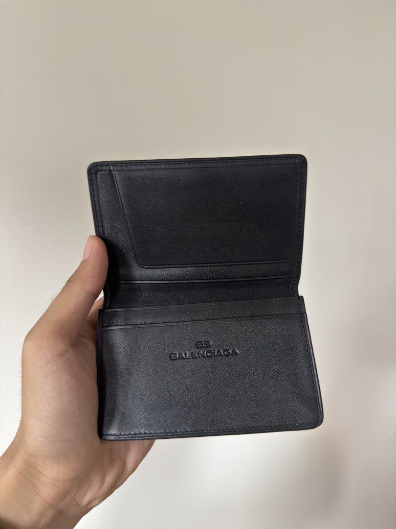 Balenciaga Black Leather Card Holder (Category: Luxury Bags & Wallets) located in Manila. Submitted by yourboy.ad (Listing ID 1442973779, Image 2). Description: - Authentic Balenciaga card holder - Color: Black leather - Embossed Balenciaga logo inside - Multiple card slots for organization - Slim and pocket-friendly design - Minimalist and stylish.