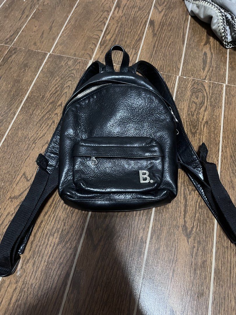 Balenciaga Black Leather Mini Backpack (Category: Luxury Bags & Wallets) located in Victorias. Submitted by lan1877 (Listing ID 1443029597, Image 1). Description: - Authentic Balenciaga black leather mini backpack - Iconic 'B.' logo on the front pocket - Main compartment and front zip pocket for organization - Adjustable straps for comfortable wear Rank A No issue 8k plus sf - Expertly crafted in Italy - Ideal for everyday style and practicality.