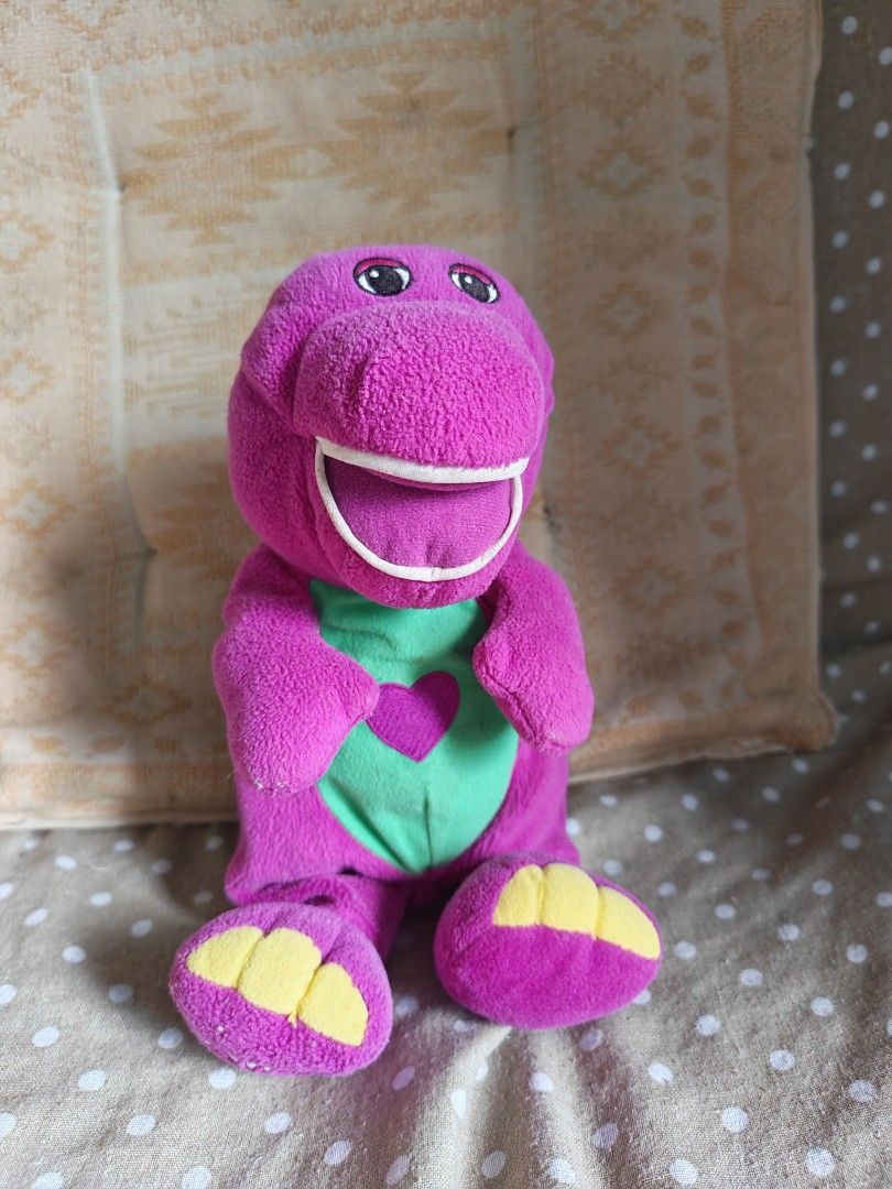 Barney the Dinosaur Plush Toy (Category: Plushies & Soft Toys) located in Carmona. Submitted by tech_hub_cavite (Listing ID 1442971672, Image 1). Description: - Adorable purple Barney plush toy - Features a green vest with a cute pink heart - Incredibly soft and cuddly material - A must-have for all Barney enthusiasts - Ready to bring joy to a new home.