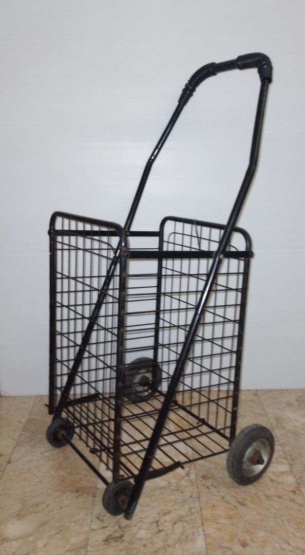 Black Folding Shopping Cart Trolley (Category: Everything Else Others) located in Pasig City. Submitted by eclectic_stuff (Listing ID 1442996054, Image 3). Description: - Sturdy black metal shopping cart - Folds flat for easy storage - Smooth-rolling wheels and sturdy handle (4-wheeled) - Perfect for groceries, laundry, and more - Minor cosmetic scuffs from normal use, but fully functional ■Height> 33" tall Flaw- 1-metal strip on 1-side removed..