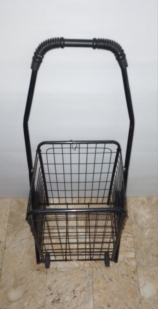 Black Folding Shopping Cart Trolley (Category: Everything Else Others) located in Pasig City. Submitted by eclectic_stuff (Listing ID 1442996054, Image 2). Description: - Sturdy black metal shopping cart - Folds flat for easy storage - Smooth-rolling wheels and sturdy handle (4-wheeled) - Perfect for groceries, laundry, and more - Minor cosmetic scuffs from normal use, but fully functional ■Height> 33" tall Flaw- 1-metal strip on 1-side removed..