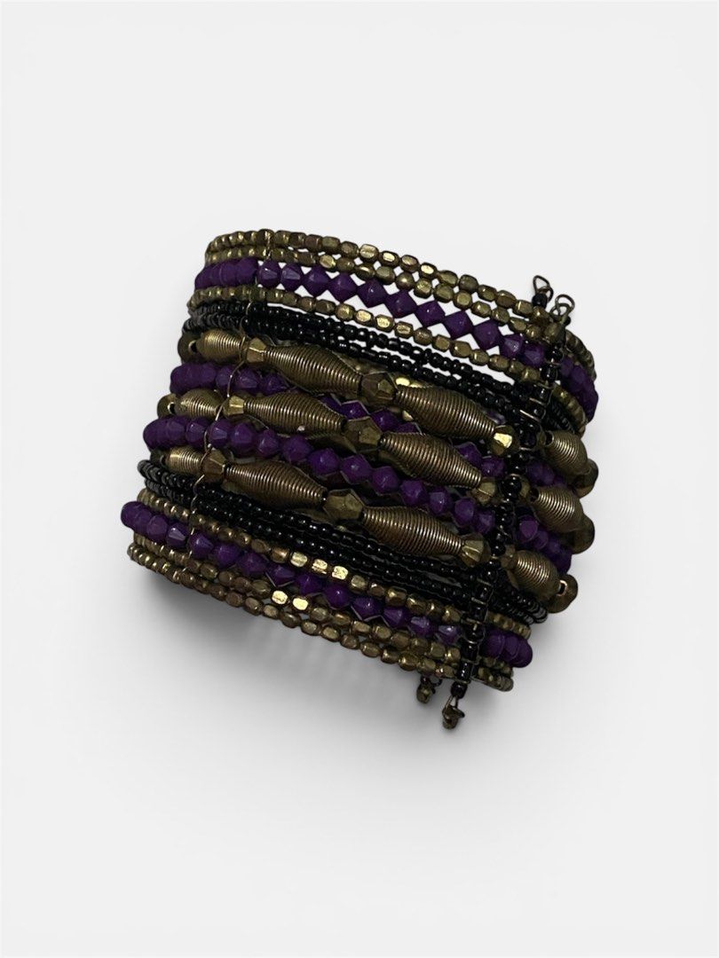 Boho Beaded Cuff Bracelet Purple and Gold Tones (Category: Bracelets) located in Gapan. Submitted by sonikku (Listing ID 1443049846, Image 2). Description: - Boho-style cuff bracelet - Features layers of purple beads - Gold-toned metal accents, some resembling springs/coils - Wide, statement piece - Adds flair to any outfit.