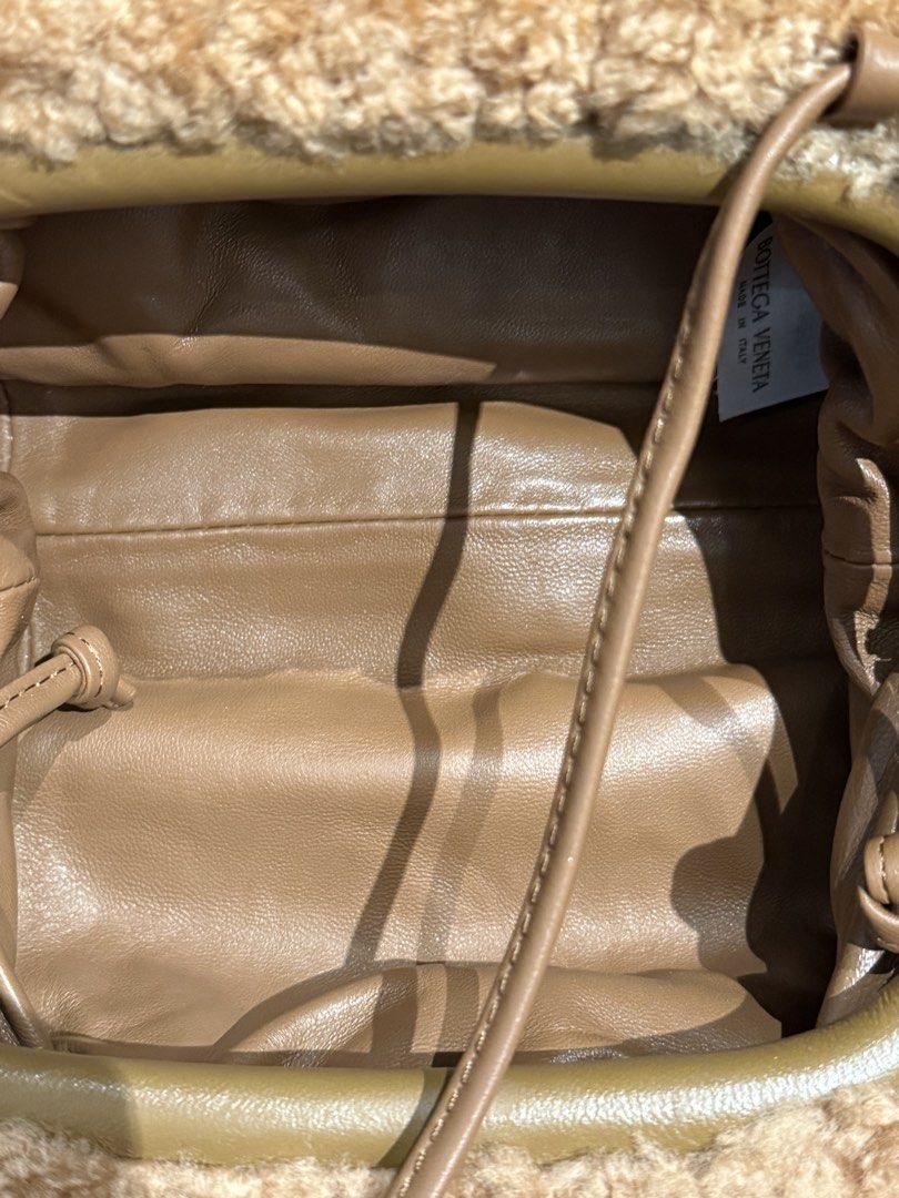Bottega Veneta Shearling Clutch Bag (Category: Luxury Bags & Wallets) located in Caloocan City. Submitted by mightbagsph23 (Listing ID 1442997515, Image 3). Description: - Brown shearling clutch - Genuine leather strap - Bottega Veneta logo inside - Made in Italy - Gathered top closure - Spacious interior with leather lining - Ideal for evening wear or as a statement accessory.