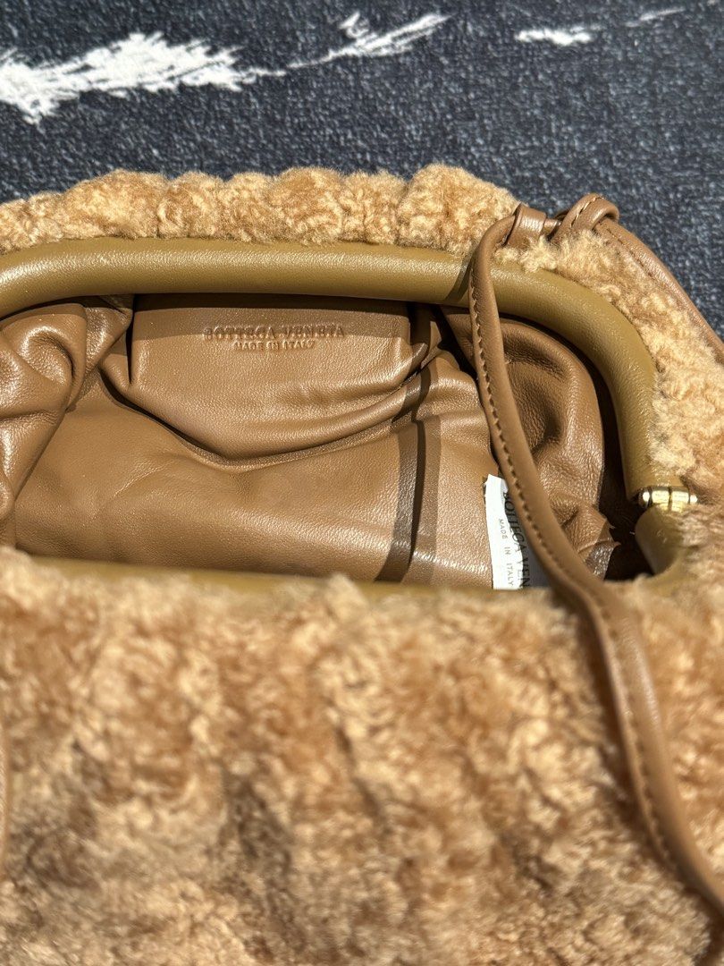 Bottega Veneta Shearling Clutch Bag (Category: Luxury Bags & Wallets) located in Caloocan City. Submitted by mightbagsph23 (Listing ID 1442997515, Image 1). Description: - Brown shearling clutch - Genuine leather strap - Bottega Veneta logo inside - Made in Italy - Gathered top closure - Spacious interior with leather lining - Ideal for evening wear or as a statement accessory.