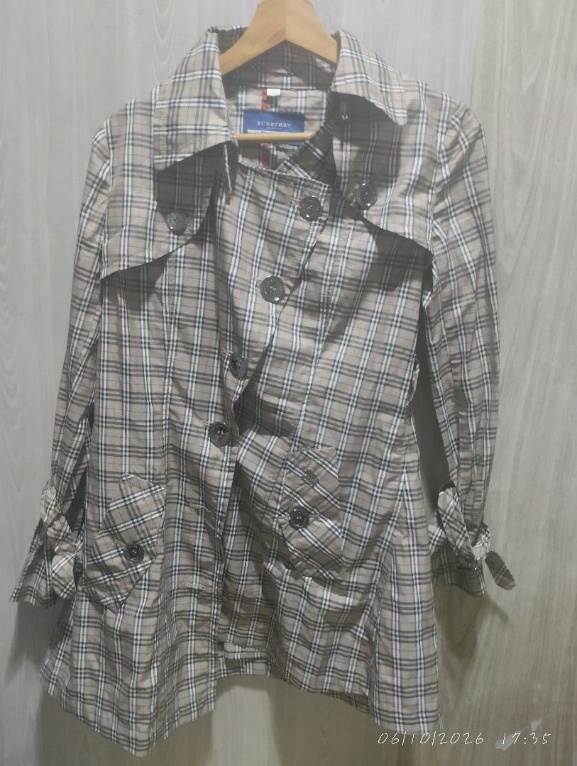 Burberry blue label trench coat (Category: Luxury Apparel) located in Bacoor. Submitted by nigel_008 (Listing ID 1443037698, Image 1). Description: Burberry blue label trench coat features the brand's signature Nova Check pattern and button down issue missing one button.