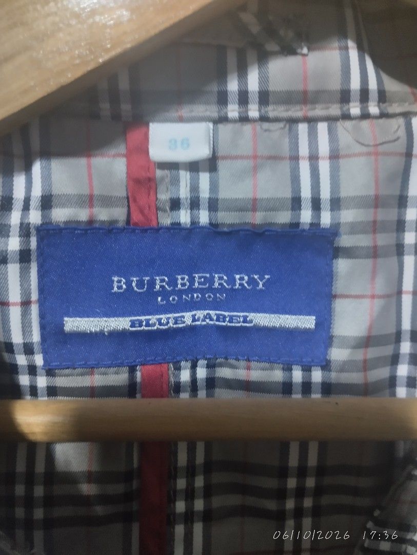 Burberry blue label trench coat (Category: Luxury Apparel) located in Bacoor. Submitted by nigel_008 (Listing ID 1443037698, Image 2). Description: Burberry blue label trench coat features the brand's signature Nova Check pattern and button down issue missing one button.