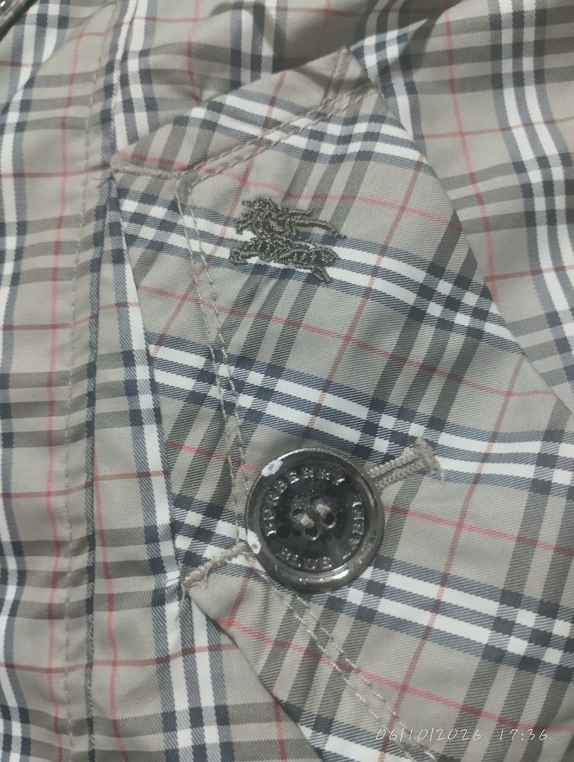 Burberry blue label trench coat (Category: Luxury Apparel) located in Bacoor. Submitted by nigel_008 (Listing ID 1443037698, Image 3). Description: Burberry blue label trench coat features the brand's signature Nova Check pattern and button down issue missing one button.