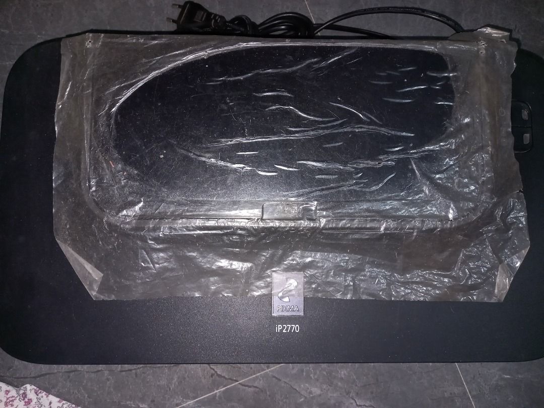 Canon PIXMA iP2770 Printer (Category: Printers, Scanners & Copiers) located in Cavite. Submitted by thriftiesie (Listing ID 1442955909, Image 3). Description: - Canon PIXMA iP2770 printer - Color: Black - Top cover is open and covered with plastic wrap - Sold as is -working but with no cartridge -negotiable.