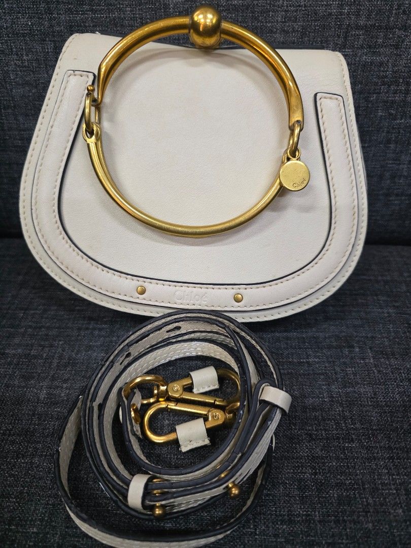 Chloe Nile Bracelet Bag White Leather (Category: Luxury Bags & Wallets) located in General Trias. Submitted by roselle2230 (Listing ID 1442991775, Image 3). Description: - Authentic white leather Chloe bag - Features the iconic bracelet handle - Includes a detachable shoulder strap for versatility - Interior card slots for essentials - Elegant gold hardware - Ideal for both daytime and evening use.