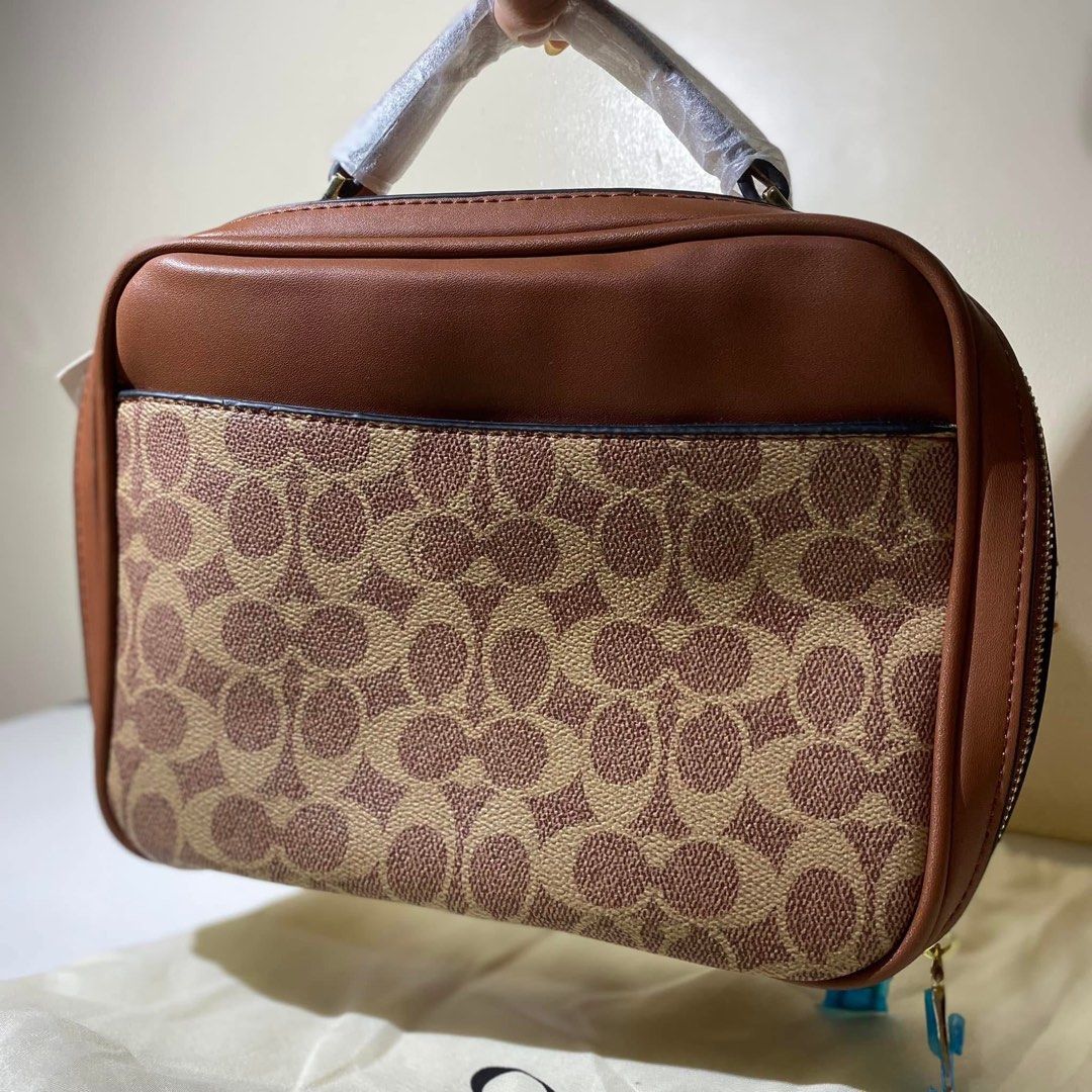 Coach 703 Coated Canvas Lunchbox Bag (Category: Purses & Pouches) located in Calamba. Submitted by declutter.rebski (Listing ID 1442971509, Image 3). Description: Coach 703 Coated Canvas Lunchbox Bag ₱500 A stylish everyday bag featuring Coach’s signature coated canvas design. Compact yet spacious enough for your daily essentials, with a long strap for convenient wear. Details: • Never been used • Has flaws due to storage (see photos) • Includes 