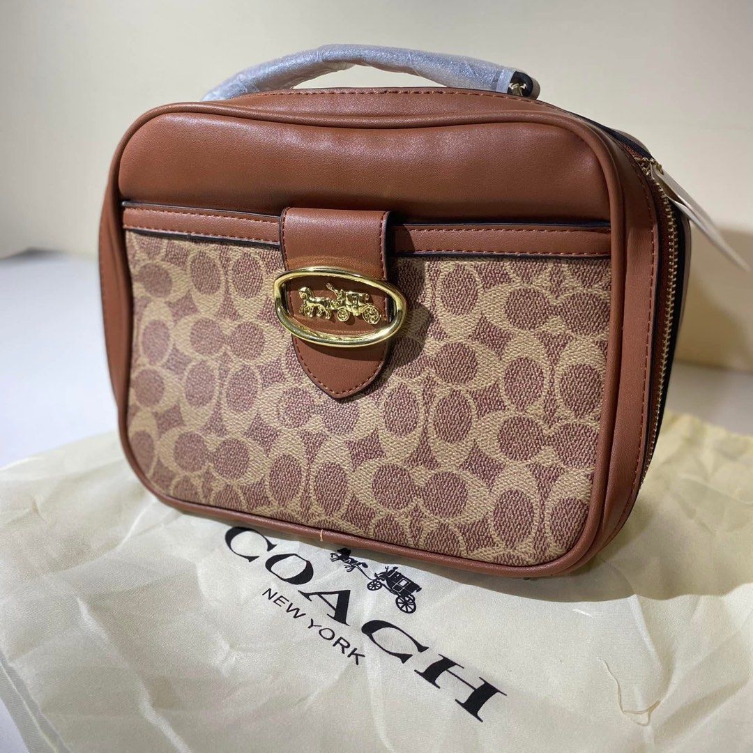 Coach 703 Coated Canvas Lunchbox Bag (Category: Purses & Pouches) located in Calamba. Submitted by declutter.rebski (Listing ID 1442971509, Image 2). Description: Coach 703 Coated Canvas Lunchbox Bag ₱500 A stylish everyday bag featuring Coach’s signature coated canvas design. Compact yet spacious enough for your daily essentials, with a long strap for convenient wear. Details: • Never been used • Has flaws due to storage (see photos) • Includes 