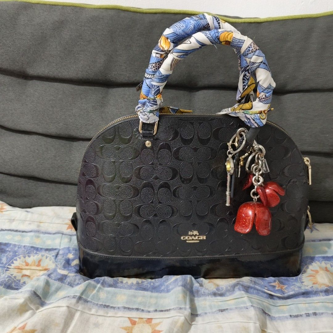 Coach handbag (Category: Luxury Bags & Wallets) located in Manila. Submitted by miss_aprilp (Listing ID 1443032587, Image 1). Description: Coach handbag Honest issue: Visible wear on the handle attachments, Body of the bag still looks structurally sound, Includes decorative accessories/scarf, which add a little appeal.