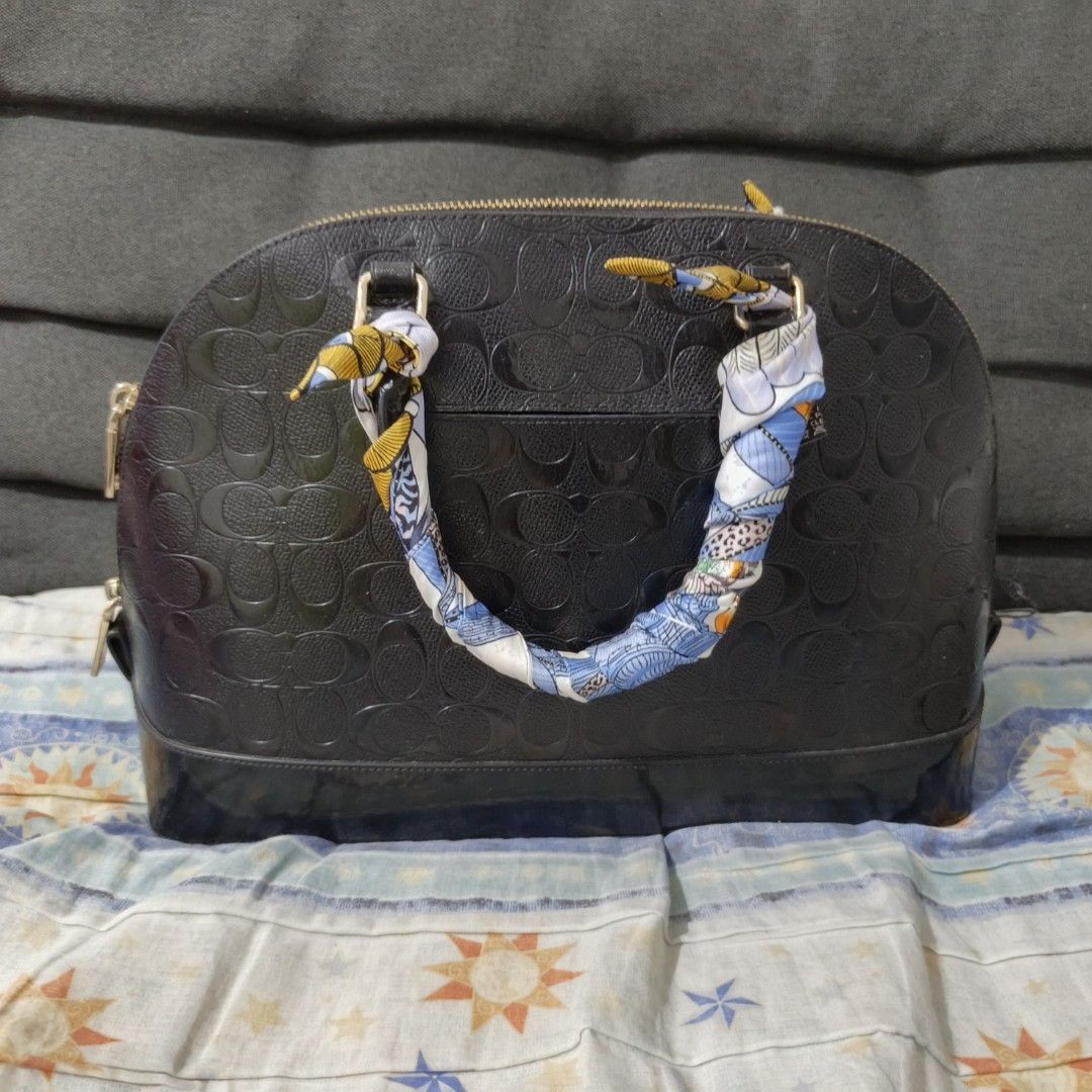 Coach handbag (Category: Luxury Bags & Wallets) located in Manila. Submitted by miss_aprilp (Listing ID 1443032587, Image 3). Description: Coach handbag Honest issue: Visible wear on the handle attachments, Body of the bag still looks structurally sound, Includes decorative accessories/scarf, which add a little appeal.