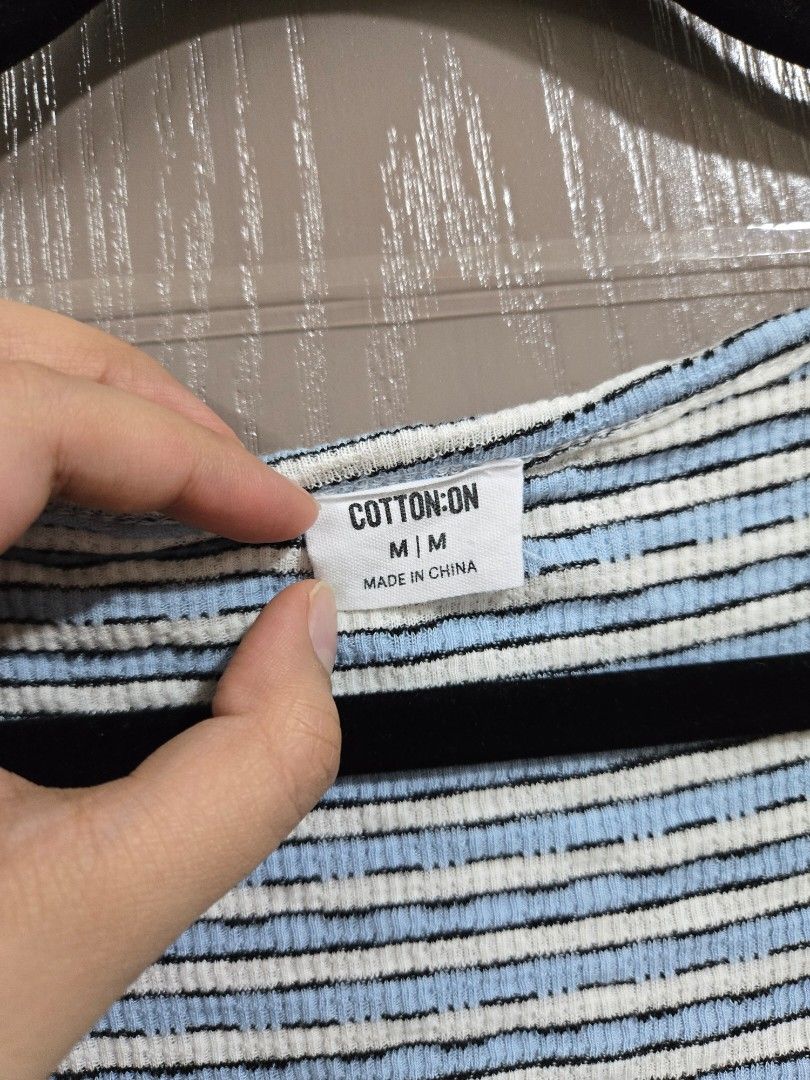 Cotton On Striped Ribbed Mock Neck Top (Category: Sleeveless) located in Rizal. Submitted by marrenkeithly (Listing ID 1443081665, Image 2). Description: - Blue and white striped top from Cotton On - Ribbed texture - Mock neck - Estimated size M - Versatile for layering or standalone wear - Easily pairs with jeans or skirts.