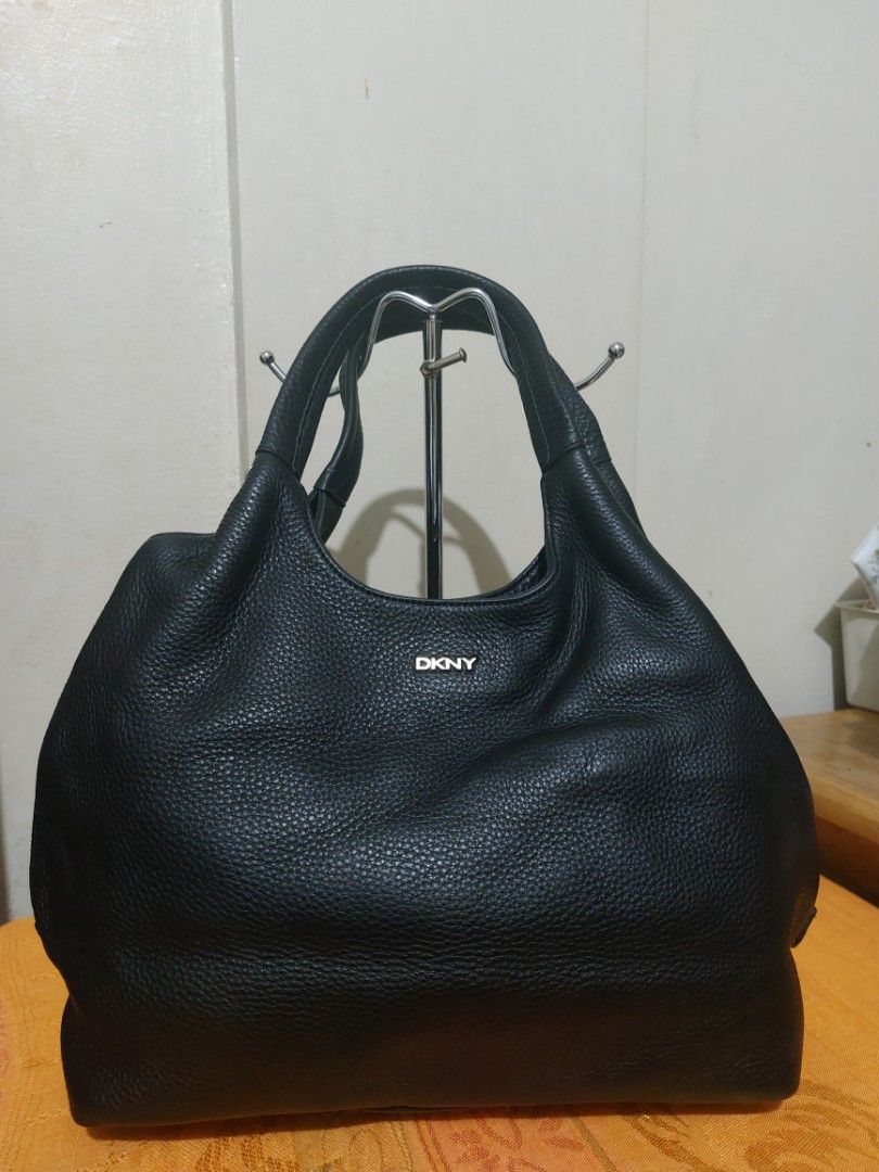 DKNY Black Leather Hobo Shoulder Bag (Category: Shoulder Bags) located in Las Pinas. Submitted by jmproperties (Listing ID 1443052957, Image 1). Description: - DKNY black leather hobo bag - Textured leather finish - Zip closure along the top - Comfortable shoulder straps - Simple and classic design - Great for everyday use - Plenty of space inside normal signs of use / pressmarks only. The bag is in very good condition.
