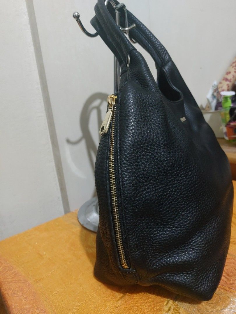 DKNY Black Leather Hobo Shoulder Bag (Category: Shoulder Bags) located in Las Pinas. Submitted by jmproperties (Listing ID 1443052957, Image 2). Description: - DKNY black leather hobo bag - Textured leather finish - Zip closure along the top - Comfortable shoulder straps - Simple and classic design - Great for everyday use - Plenty of space inside normal signs of use / pressmarks only. The bag is in very good condition.