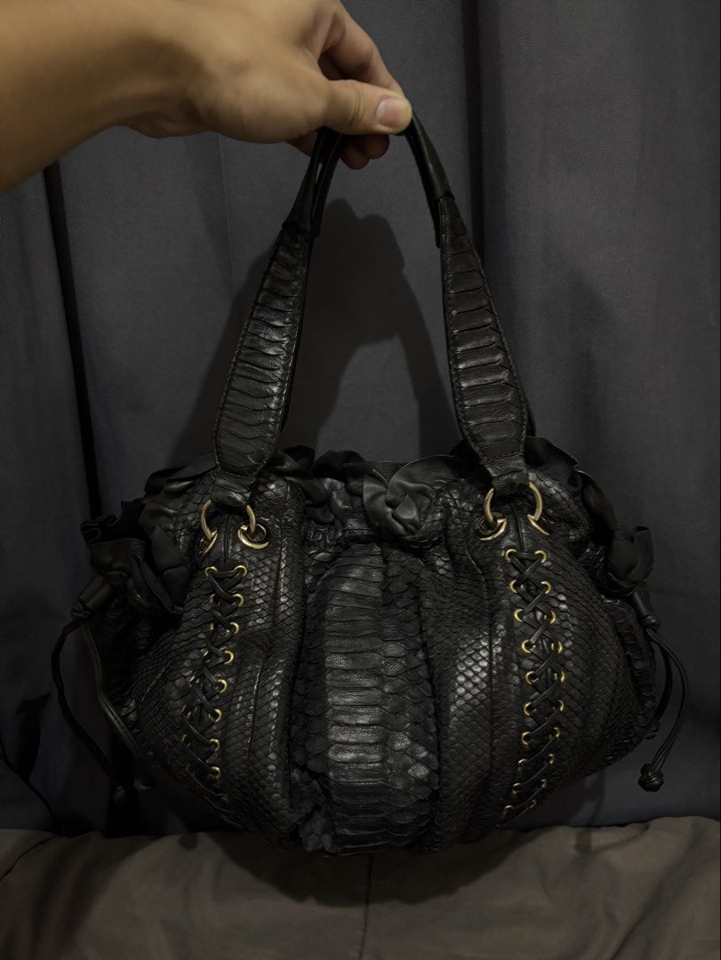 Genuine Python Shoulder Hobo Bag (Category: Luxury Bags & Wallets) located in Munoz. Submitted by lolongs (Listing ID 1443059477, Image 2). Description: - Genuine Python Skin - Exotic Skin / Snake Skin - Sobrang ganda nito. High quality ng snake leather ang ginamit. Ganda pa ng design. - Gold na gold pa ang mga hardwares - Excellent condition! Pwede sa maselan at maarte! - Please see pictures for reference - Perfect for office bag din.