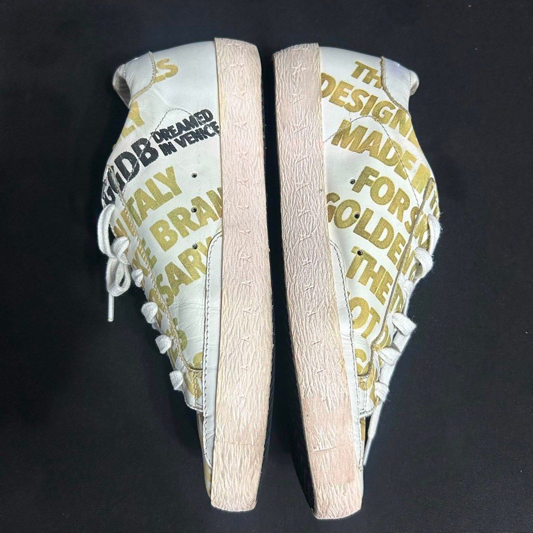 Golden Goose White Gold Logo Sneakers (Category: Sneakers) located in Davao. Submitted by msagatha (Listing ID 1443114821, Image 3). Description: - Authentic Golden Goose sneakers - Color: White and Gold with all-over logo print - Style: Lace-up - 350 out of 1000 pair worldwide (RARE) - 10th Anniversary Release - Origin: Made in Italy - Perfect for adding flair to any outfit - 100% authentic - Money Back Guarantee - Size 38 euro Rare piece and pe