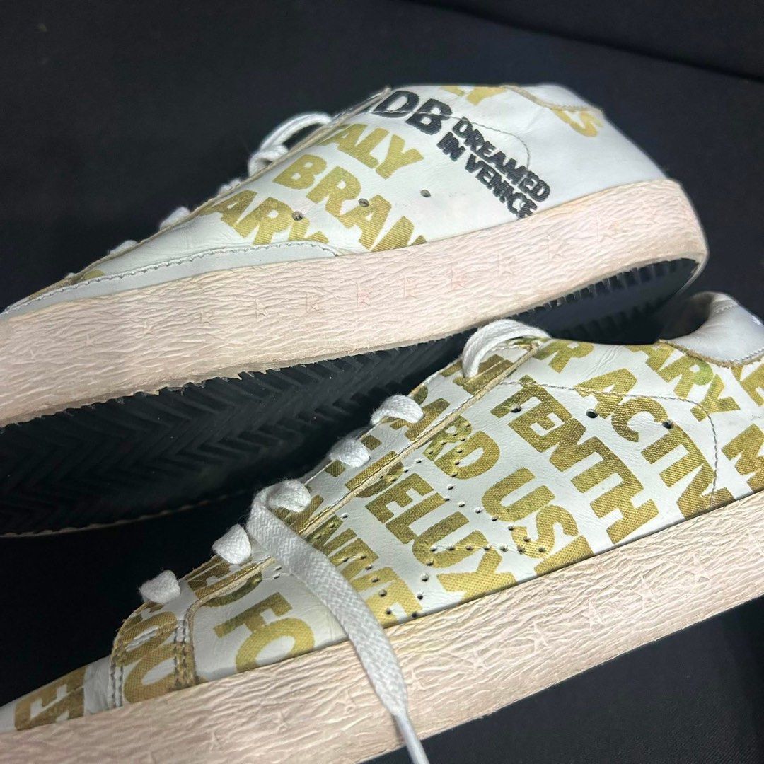 Golden Goose White Gold Logo Sneakers (Category: Sneakers) located in Davao. Submitted by msagatha (Listing ID 1443114821, Image 2). Description: - Authentic Golden Goose sneakers - Color: White and Gold with all-over logo print - Style: Lace-up - 350 out of 1000 pair worldwide (RARE) - 10th Anniversary Release - Origin: Made in Italy - Perfect for adding flair to any outfit - 100% authentic - Money Back Guarantee - Size 38 euro Rare piece and pe