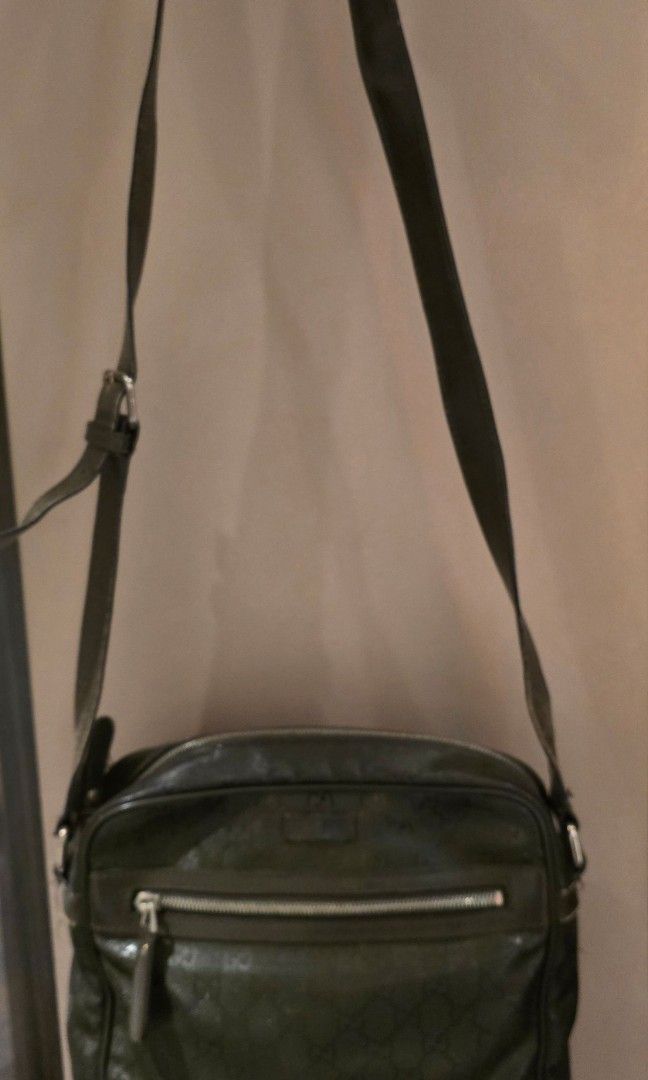 Gucci GG Monogram Crossbody Bag (Category: Luxury Bags & Wallets) located in Caloocan City. Submitted by 211sc (Listing ID 1442977584, Image 1). Description: - Authentic Gucci crossbody bag - Color: Dark green with signature GG monogram - Features a front zipper pocket - Zippers run really smooth - Adjustable strap for comfortable wear - Minor signs of wear on strap and leather trim - Perfect for everyday use - bought at the Gucci store in Hong K