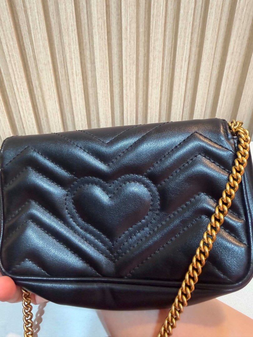 Gucci Marmont Mini Bag Black Chevron Leather (Category: Luxury Bags & Wallets) located in Quezon City. Submitted by kymis (Listing ID 1443119336, Image 3). Description: - Authentic Gucci Marmont mini bag - Black chevron leather with iconic gold GG hardware - Signature heart detail on the back - Versatile chain strap for shoulder or crossbody wear - Comes with original dust bag - Interior features a small Gucci tag for authenticity.