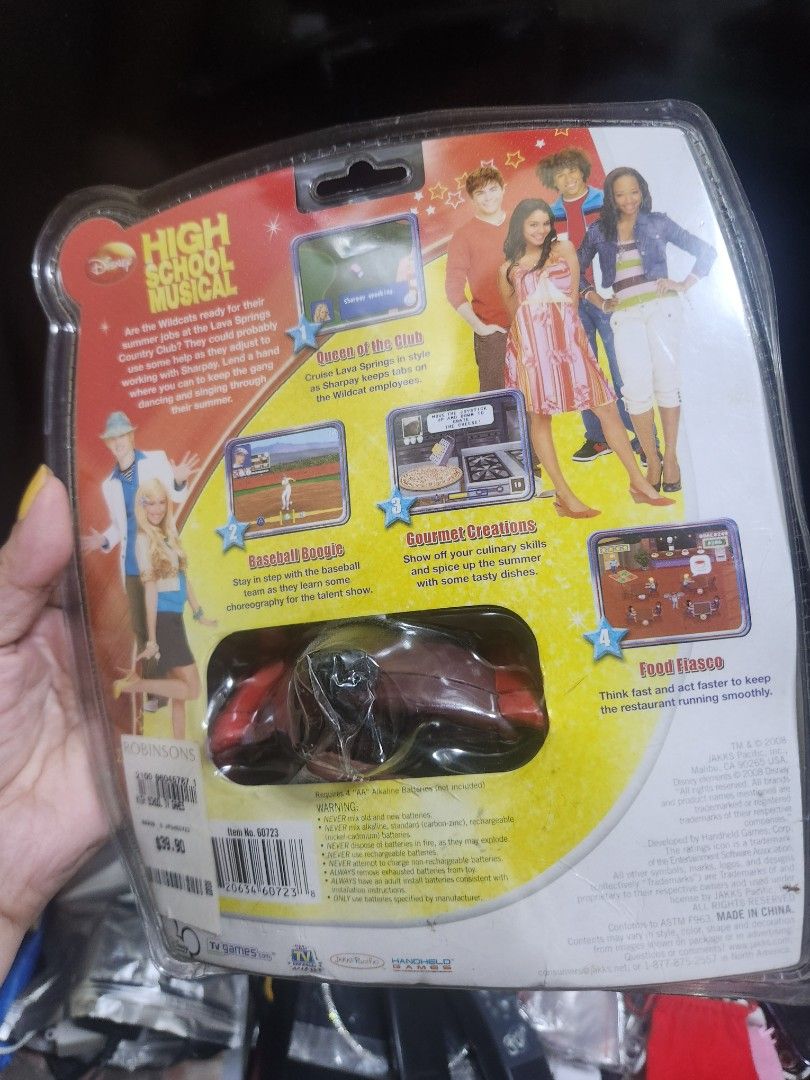 High School Musical Video Games Built Inside Toy (Category: Kids Toys) located in Pasig City. Submitted by js.authenticlux (Listing ID 1442927855, Image 2). Description: - High School Musical collectible toy - Features 'Video Games built inside!' - Includes character figure and accessories - Packaging showcases movie scenes and characters - Ideal gift for any High School Musical fan * call txt 09178029682.