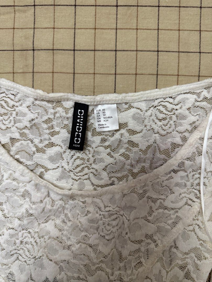 H&M Divided White Lace Long Sleeve Top (Category: Longsleeves) located in Quezon City. Submitted by m3gan8 (Listing ID 1443067981, Image 3). Description: - H&M Divided white lace top - Size XS - Long sleeves - Fitted silhouette - Delicate floral lace pattern - Ideal for layering over camisoles or bralettes.
