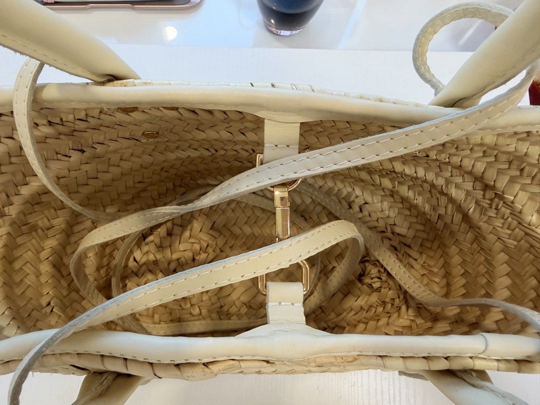 Jacquemus Straw Bag with Leather Handles (Category: Luxury Bags & Wallets) located in Quezon City. Submitted by vanid___ (Listing ID 1443033348, Image 3). Description: - Authentic Jacquemus straw bag - Natural straw weave with cream leather handles and trim - Features a gold logo leather patch on the front - Interior strap closure - Ideal for summer outings - Approximate dimensions: 10 inches wide, 7 inches tall -inclusion: none po only the bag .