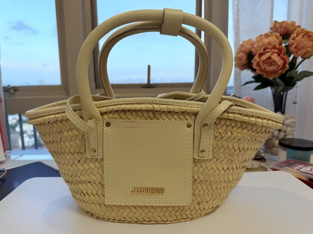 Jacquemus Straw Bag with Leather Handles (Category: Luxury Bags & Wallets) located in Quezon City. Submitted by vanid___ (Listing ID 1443033348, Image 1). Description: - Authentic Jacquemus straw bag - Natural straw weave with cream leather handles and trim - Features a gold logo leather patch on the front - Interior strap closure - Ideal for summer outings - Approximate dimensions: 10 inches wide, 7 inches tall -inclusion: none po only the bag .
