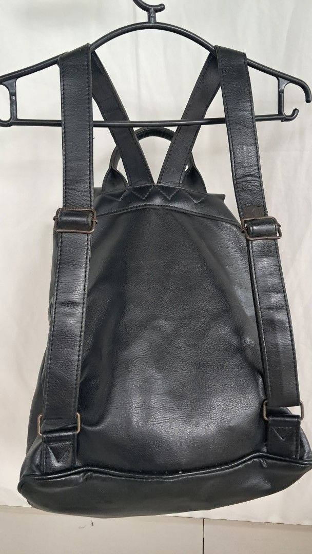 Japan Black Faux Leather Drawstring Backpack with Flap Closure (Category: Backpacks) located in Bulacan. Submitted by amarijapansurplus (Listing ID 1443019411, Image 2). Description: - Stylish black faux leather backpack - Secure drawstring closure hidden under a flap - Convenient front pocket with button closure - Adjustable straps for a comfortable fit - Ample interior space for all your essentials - Ideal for everyday use and daily commutes - 