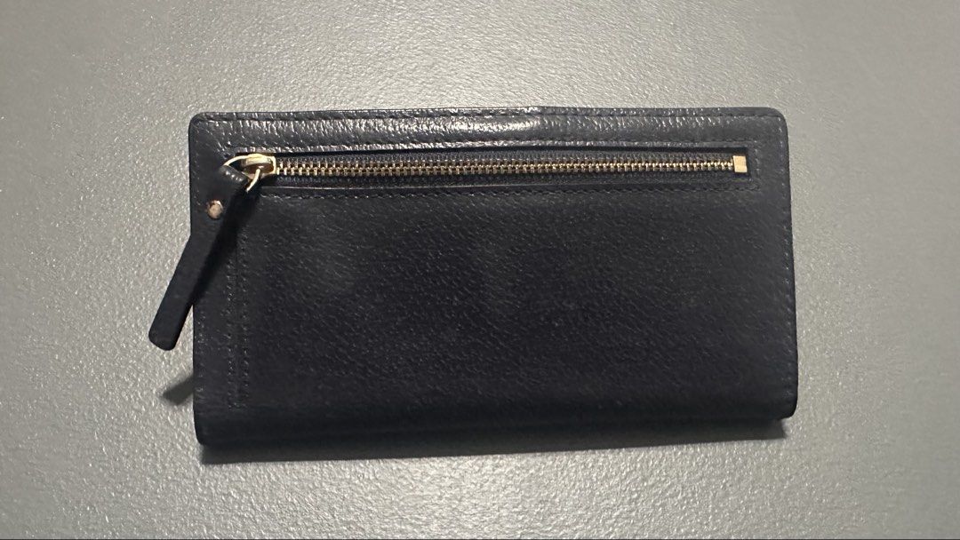 Kate Spade New York Leather Wallet (Category: Wallets & Card holders) located in Quezon City. Submitted by mystash2.o (Listing ID 1443076434, Image 2). Description: - Classic Kate Spade wallet - Navy blue leather - Multiple card slots - Back zip pocket - Gold hardware - Clean interior - Great for organizing essentials.