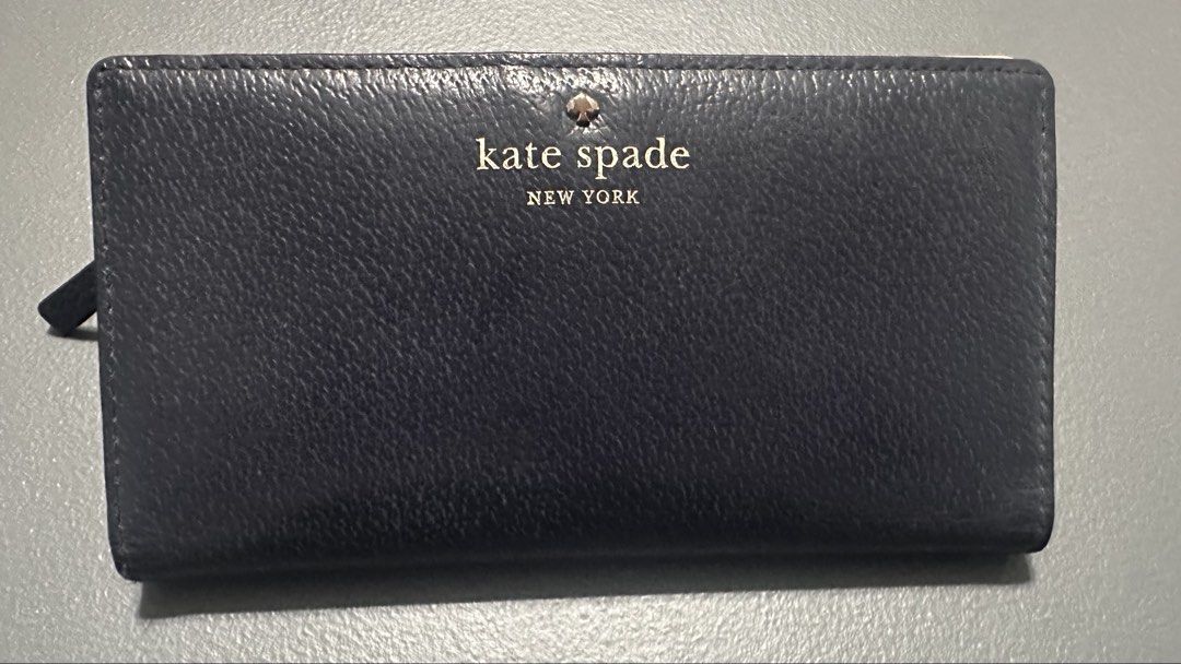 Kate Spade New York Leather Wallet (Category: Wallets & Card holders) located in Quezon City. Submitted by mystash2.o (Listing ID 1443076434, Image 1). Description: - Classic Kate Spade wallet - Navy blue leather - Multiple card slots - Back zip pocket - Gold hardware - Clean interior - Great for organizing essentials.