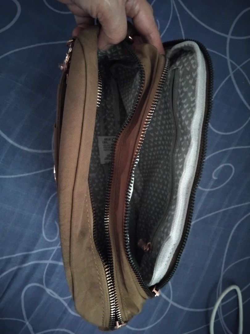 Kipling Crossbody Bag - Brown (Category: Cross-body Bags) located in Paranaque City. Submitted by leo8840 (Listing ID 1443028365, Image 3). Description: - Khaki green Kipling crossbody bag - Front pocket with snap closure - Zippered back pocket - Multiple interior compartments - Comes with signature Kipling monkey charm - Adjustable strap for comfortable wear - Ideal for everyday use.