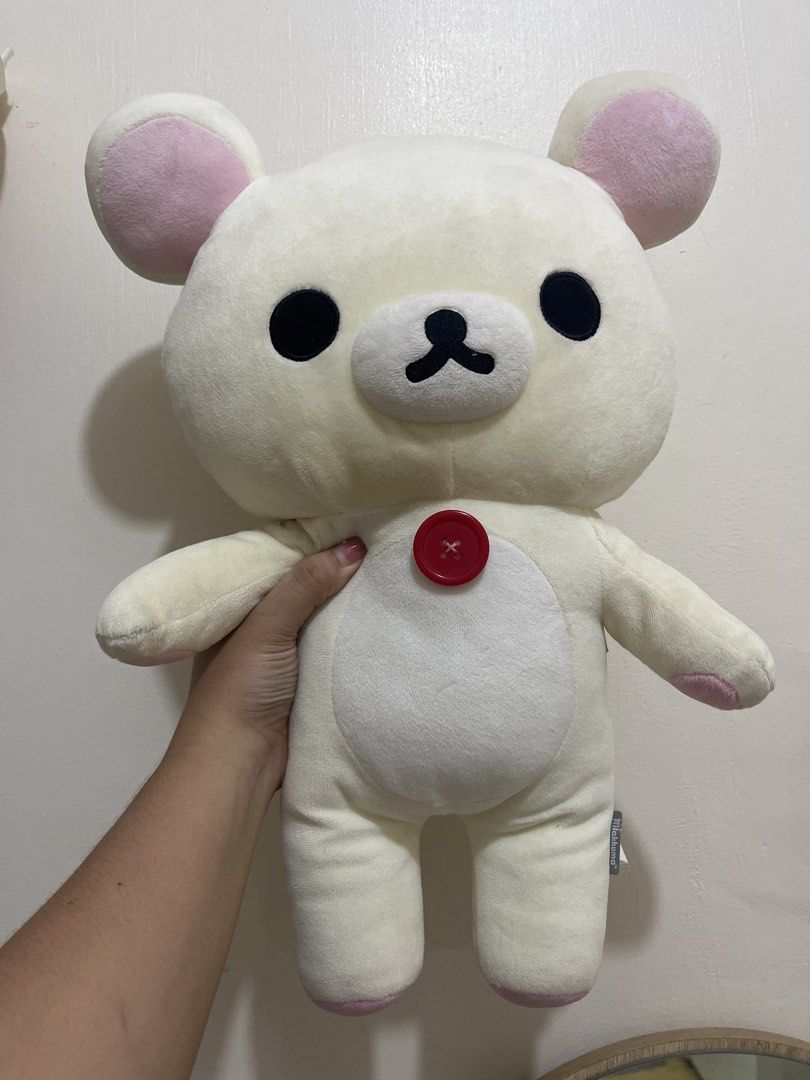 Korilakkuma - Rilakkuma Plush Toy with Red Button (Category: Plushies & Soft Toys) located in Candelaria. Submitted by wishizen (Listing ID 1443063867, Image 1). Description: - 30cm Big Rilakkuma plush toy. - Cream colored body with charming pink inner ears and paw pads. - Features a cute red button detail on its chest. - Exceptionally soft and perfect for hugging. - A must-have collectible for any Rilakkuma fan!.