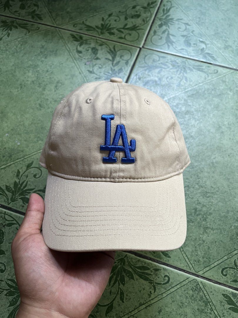LA Dodgers Baseball Cap MLB Tan Blue (Category: Caps & Hats) located in Quezon City. Submitted by flip_da_cash (Listing ID 1442989860, Image 1). Description: - Tan baseball cap - Blue LA Dodgers logo - MLB branding on back and inside - Adjustable strap for a custom fit - Perfect for casual wear or showing team pride - Clean and ready for its new owner.