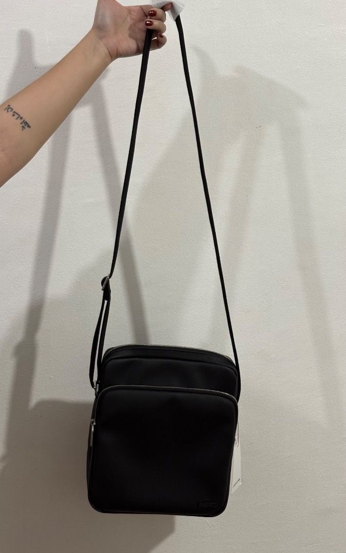 Lacoste Black Crossbody Messenger Bag (Category: Cross-body Bags) located in Caloocan City. Submitted by jcxsantos (Listing ID 1443004130, Image 3). Description: - Authentic Black Lacoste Crossbody Bag - Textured Material - Adjustable Strap - Main Zippered Compartment - Front Zippered Pocket - Brand New with Original Tags Attached - Ideal for Everyday Use.