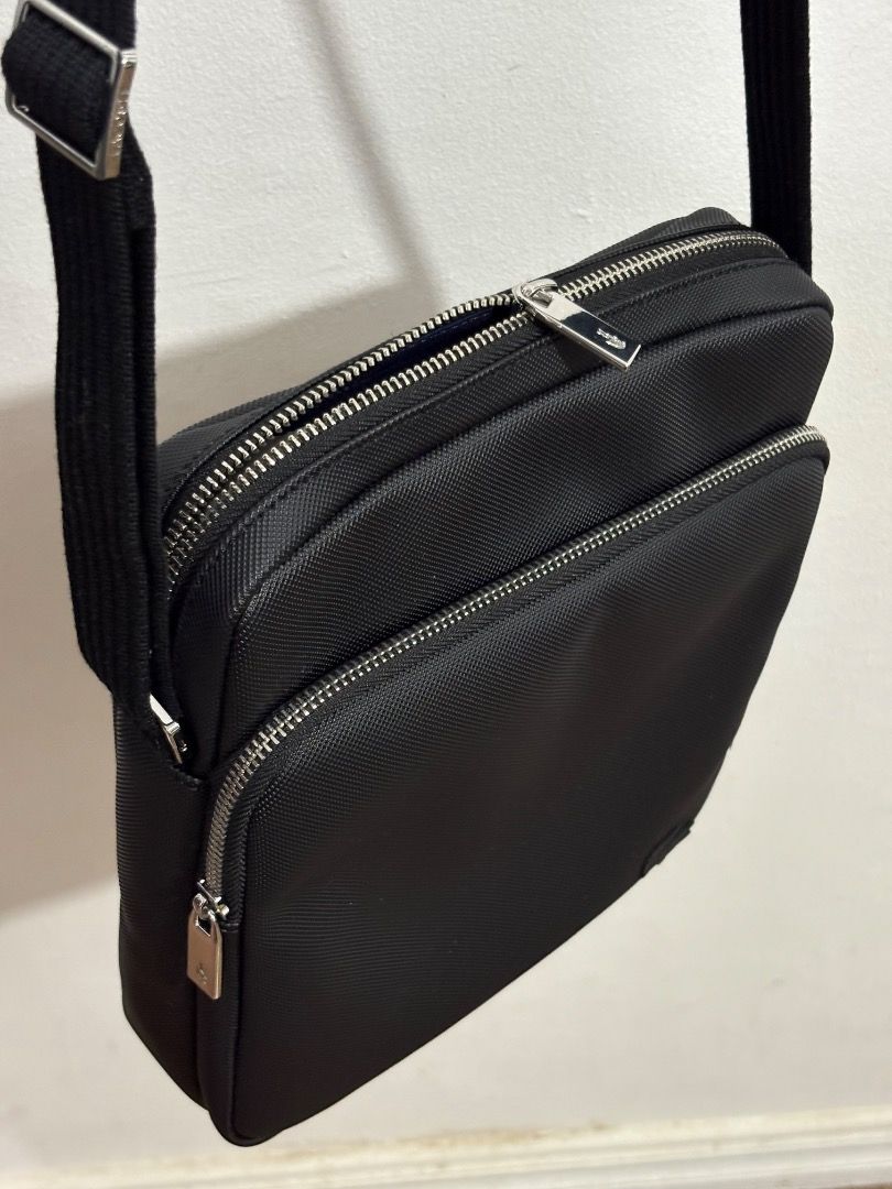 Lacoste Black Crossbody Messenger Bag (Category: Cross-body Bags) located in Caloocan City. Submitted by jcxsantos (Listing ID 1443004130, Image 2). Description: - Authentic Black Lacoste Crossbody Bag - Textured Material - Adjustable Strap - Main Zippered Compartment - Front Zippered Pocket - Brand New with Original Tags Attached - Ideal for Everyday Use.