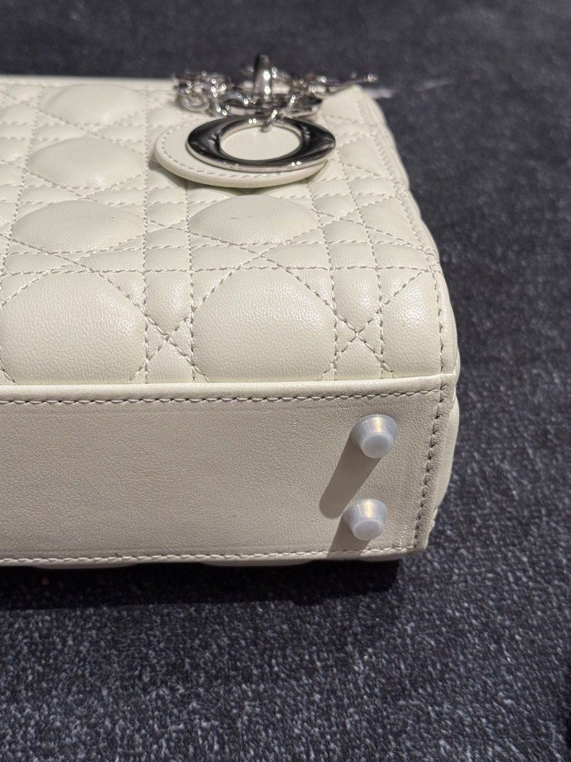 Lady Dior Mini in White Silver hardware (Category: Luxury Bags & Wallets) located in Caloocan City. Submitted by mightbagsph23 (Listing ID 1442997195, Image 3). Description: - White Dior Lady Dior Mini Bag - Quilted Cannage Leather - Silver-tone Hardware with 'D', 'I', 'O', 'R' Charms - Top Handle and Detachable Strap - Four Protective Feet on Bottom - Clean Interior - Classic and Timeless Piece.