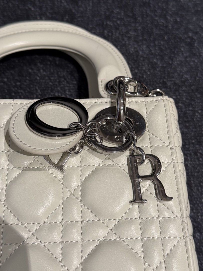 Lady Dior Mini in White Silver hardware (Category: Luxury Bags & Wallets) located in Caloocan City. Submitted by mightbagsph23 (Listing ID 1442997195, Image 2). Description: - White Dior Lady Dior Mini Bag - Quilted Cannage Leather - Silver-tone Hardware with 'D', 'I', 'O', 'R' Charms - Top Handle and Detachable Strap - Four Protective Feet on Bottom - Clean Interior - Classic and Timeless Piece.