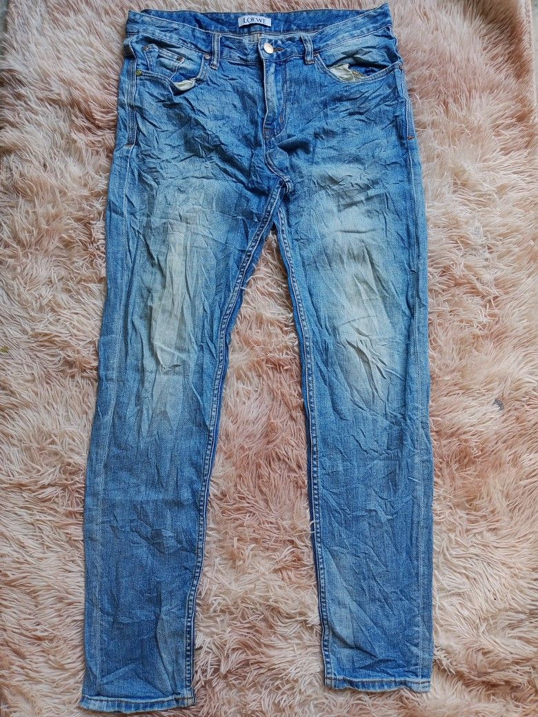 LOEWE Blue Denim Jeans Size 32 (Category: Jeans) located in Boston. Submitted by johnpaulvi30029 (Listing ID 1443009417, Image 2). Description: - Brand: LOEWE - Color: Blue Denim - Size: 32 - Fit: Classic Straight Leg - Features: Iconic LOEWE logo on back pocket, Leather patch at waist - Occasion: Great for everyday wear - Inquiries: Feel free to ask any questions!.