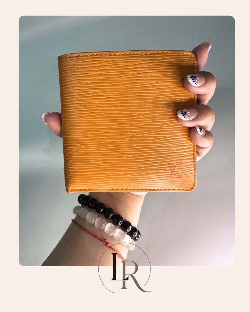 Louis Vuitton Epi Leather Bi-Fold Wallet (Category: Luxury Bags & Wallets) located in Quezon City. Submitted by elaine_t_dj (Listing ID 1443020985, Image 2). Description: - Authentic Orange Louis Vuitton Bi-fold Wallet - Made from durable Epi leather with embossed LV logo - Interior includes multiple card slots and a coin pocket - Ideal for everyday essentials and stylish use.